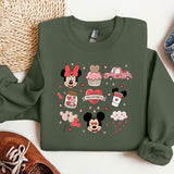 a green sweatshirt with mickey mouse and minnie mouse on it