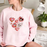 a woman sitting on a bed wearing a pink mickey mouse sweatshirt