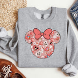 a gray shirt with a pink bow on it