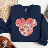 a mickey mouse sweatshirt with a pink bow on it