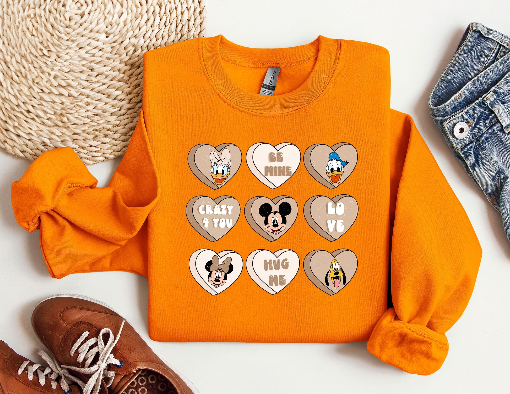 a pair of shoes and an orange shirt with mickey mouse hearts