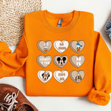a pair of shoes and an orange shirt with mickey mouse hearts
