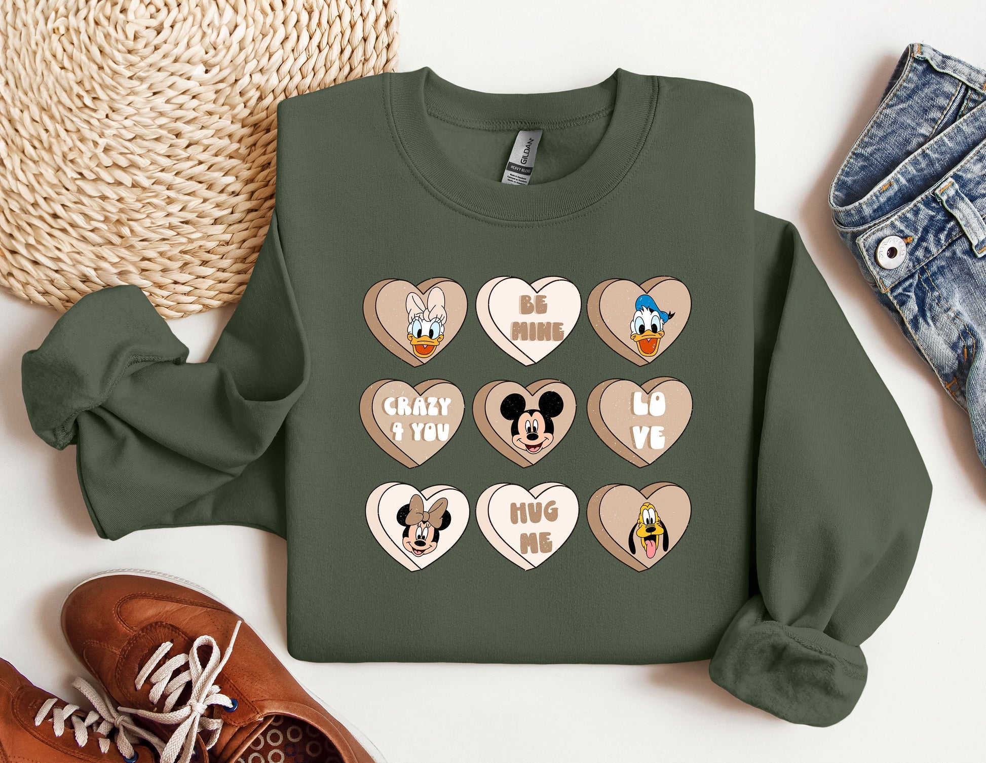 a green sweatshirt with mickey mouse and mickey mouse hearts