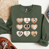 a green sweatshirt with mickey mouse and mickey mouse hearts