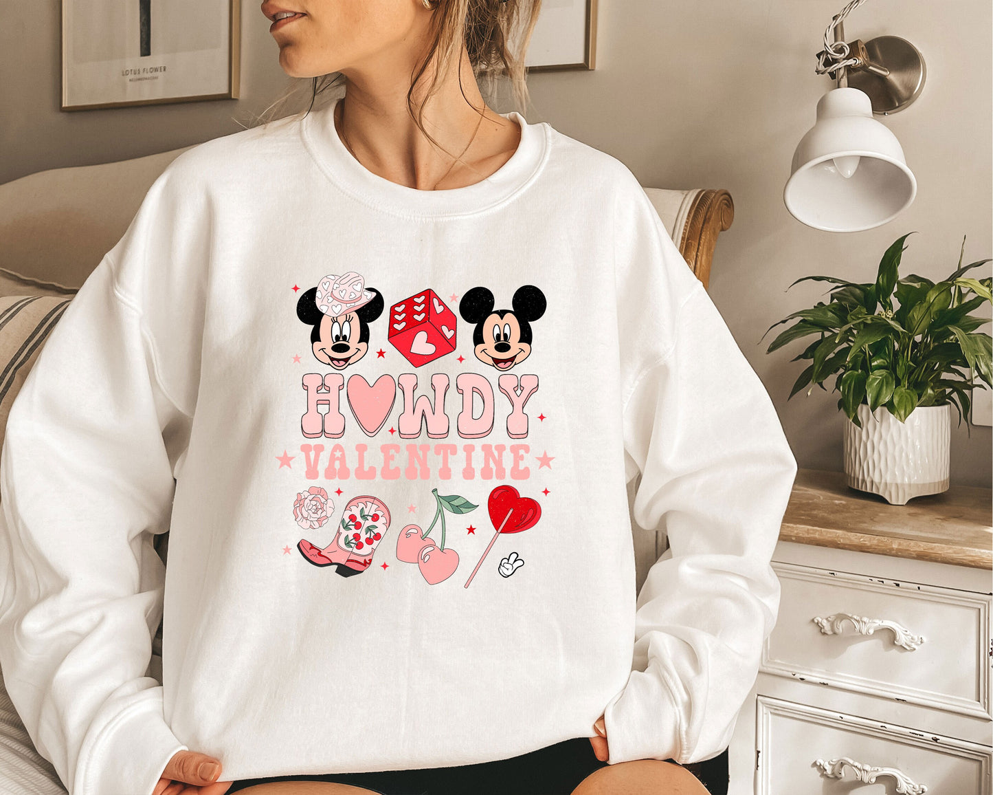 a woman wearing a sweatshirt with minnie and mickey mouse on it