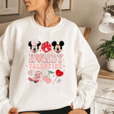 a woman wearing a sweatshirt with minnie and mickey mouse on it