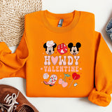 a pair of shoes and a sweatshirt with mickey and minnie mouse on it