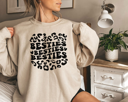 a woman wearing a sweatshirt that says besties besties