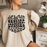 a woman wearing a sweatshirt that says besties besties