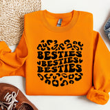 an orange sweatshirt with the words besties besties on it