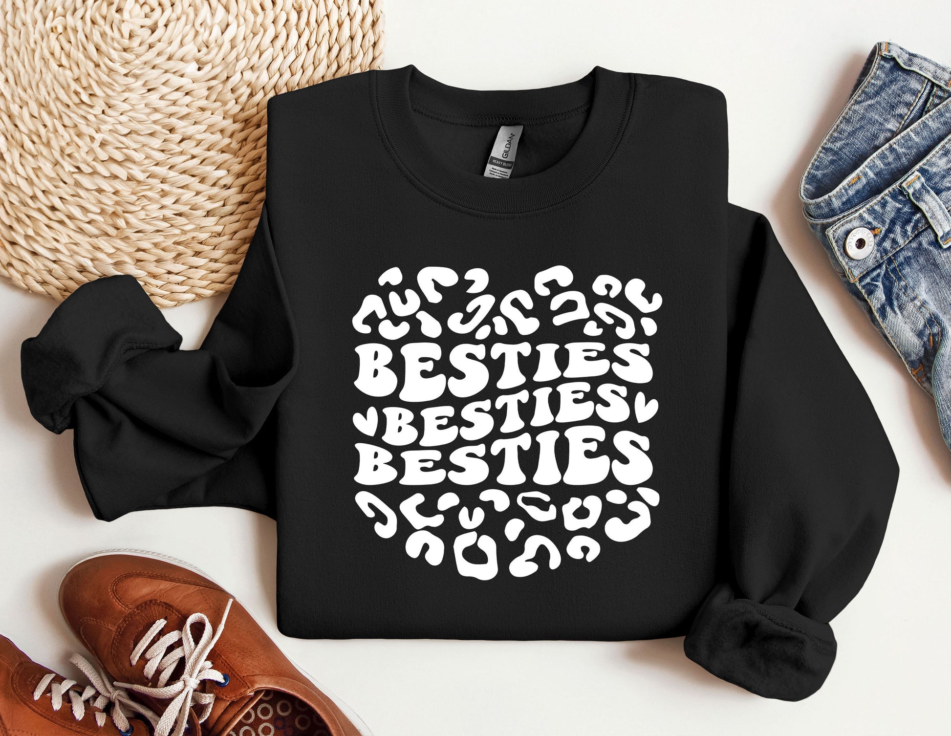 a black sweatshirt with the words besties written in white