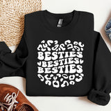 a black sweatshirt with the words besties written in white