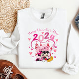 a sweater with a minnie mouse on it next to a pair of shoes