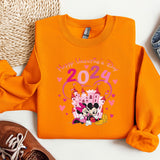 a pair of shoes and an orange shirt with a mickey mouse on it
