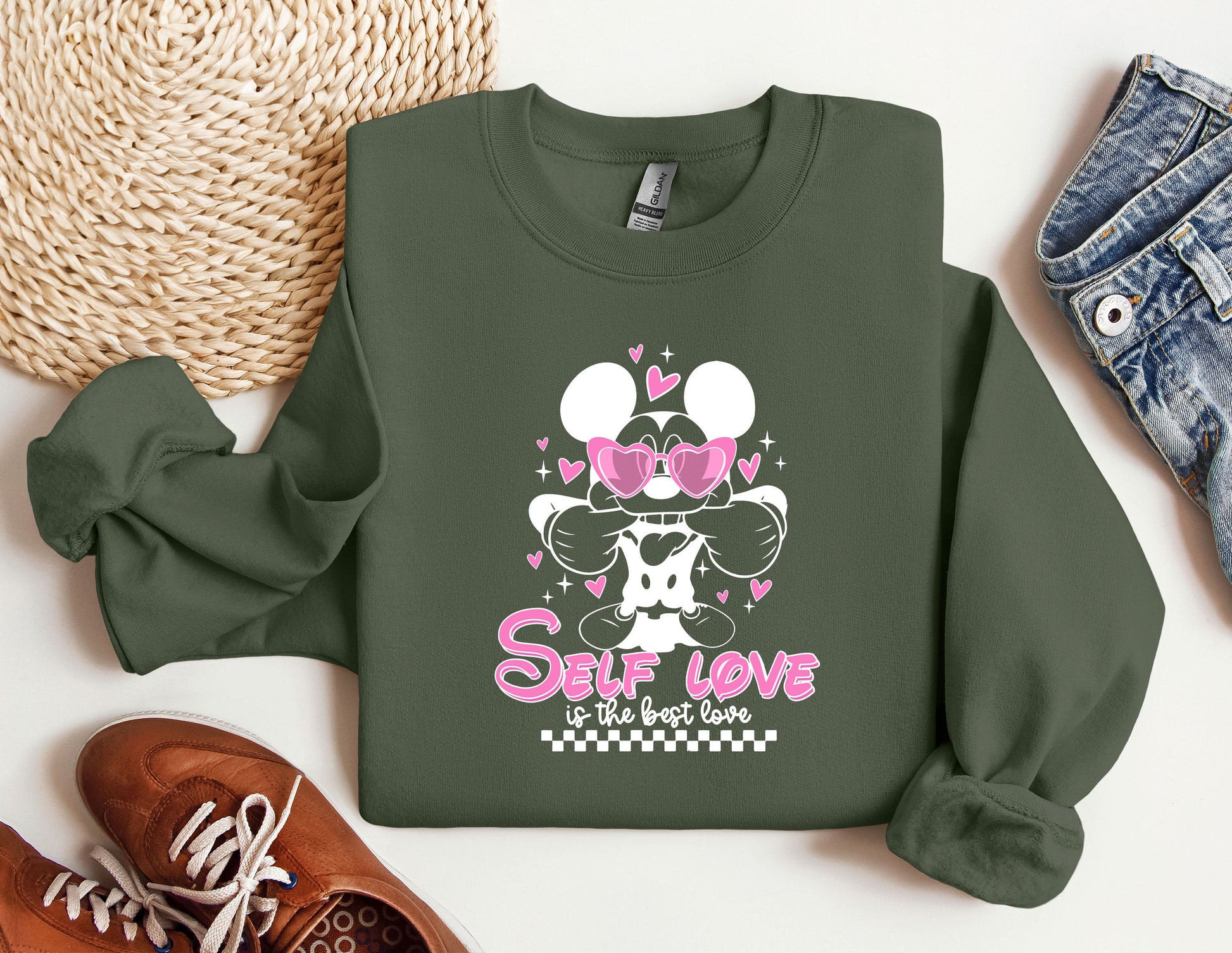 a green sweatshirt with minnie mouse on it