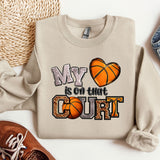 a pair of shoes and a sweatshirt with a basketball on it