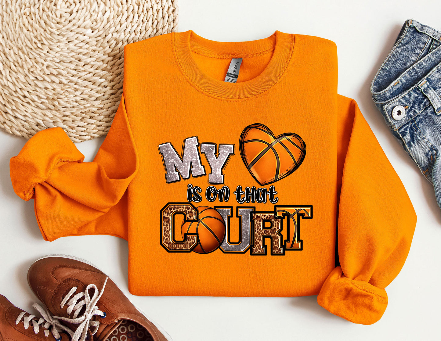 a pair of shoes and a sweatshirt with a basketball on it