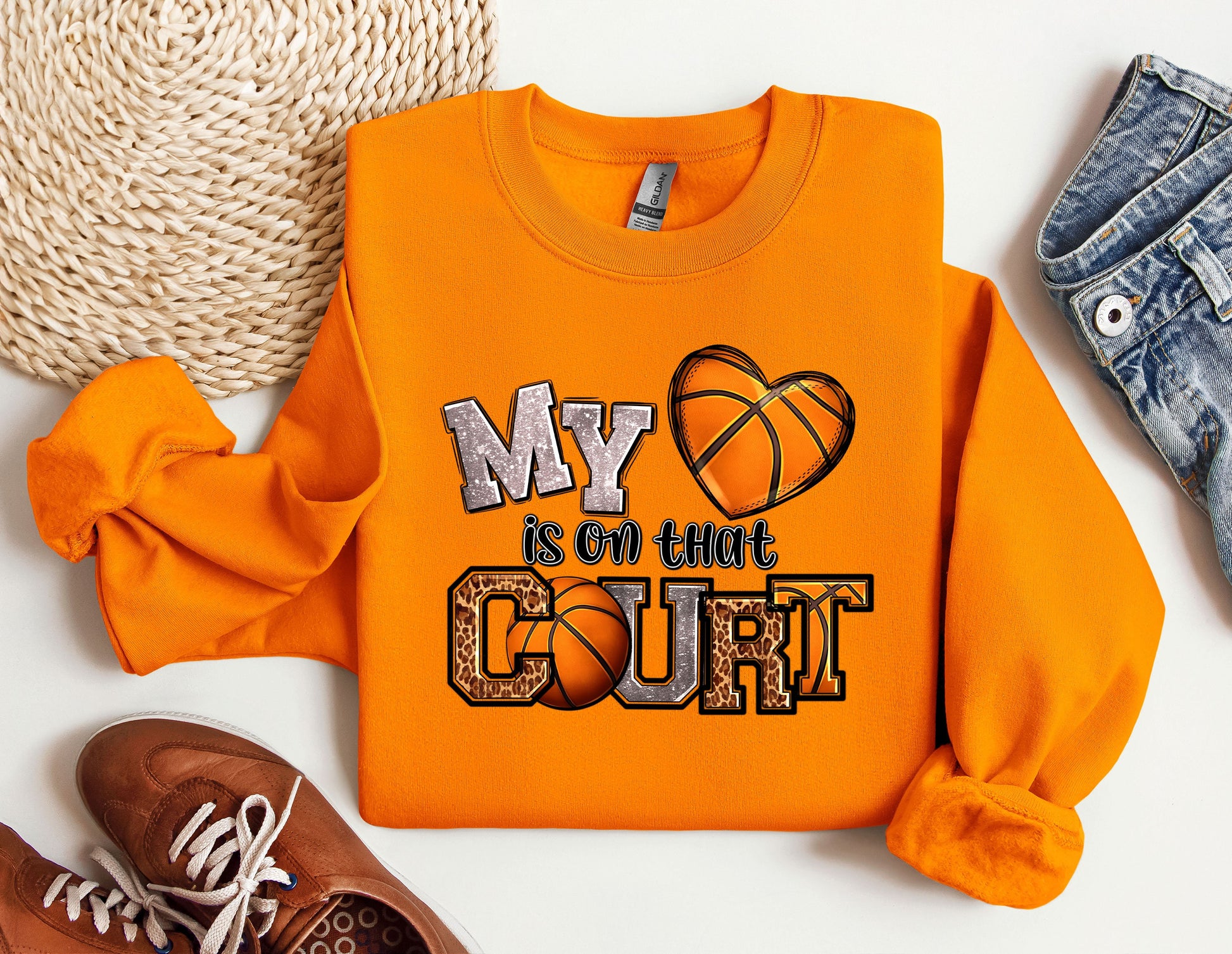 a pair of shoes and a sweatshirt with a basketball on it