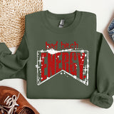 a green sweatshirt with a red and white design on it