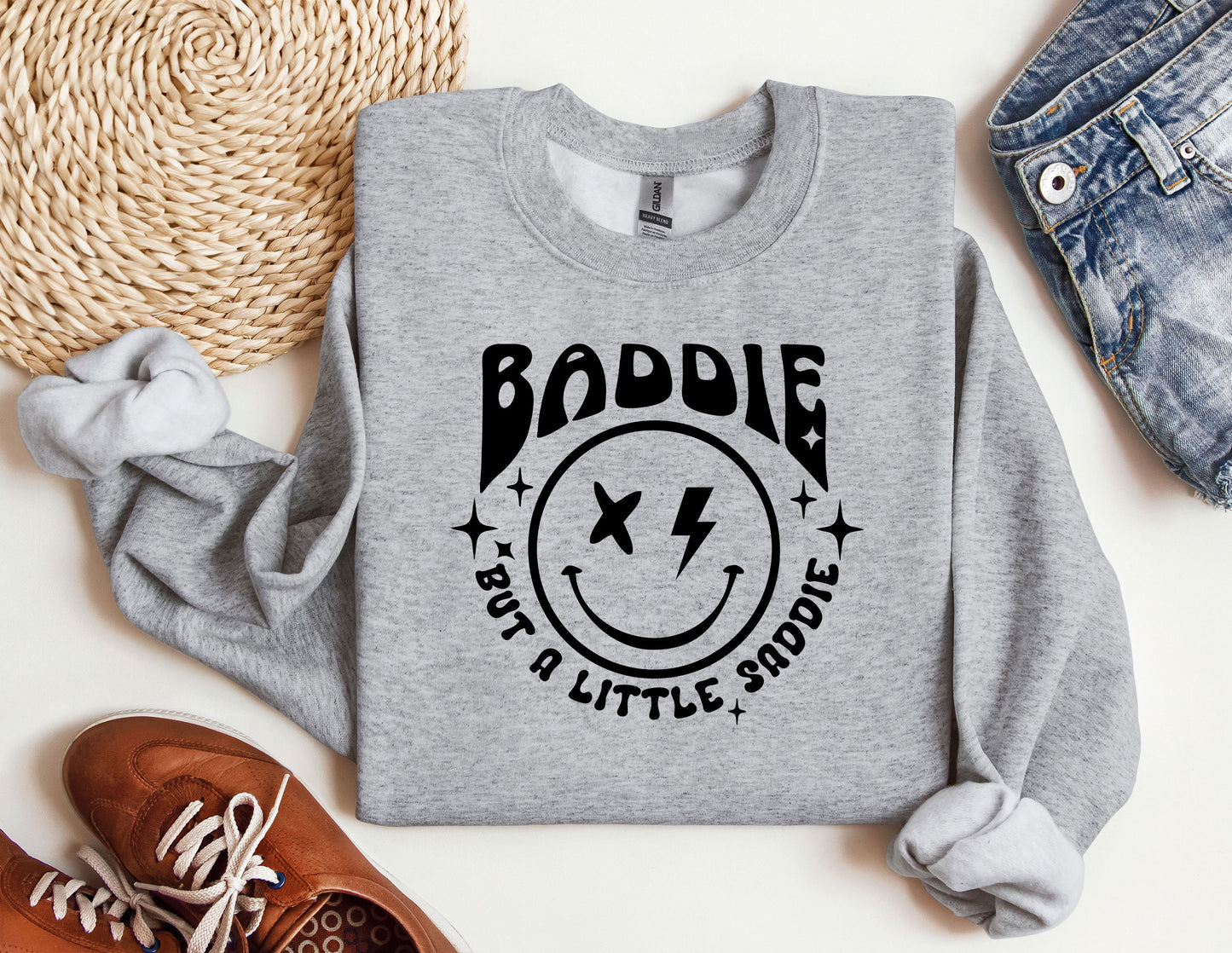 a grey sweatshirt with a smiley face on it