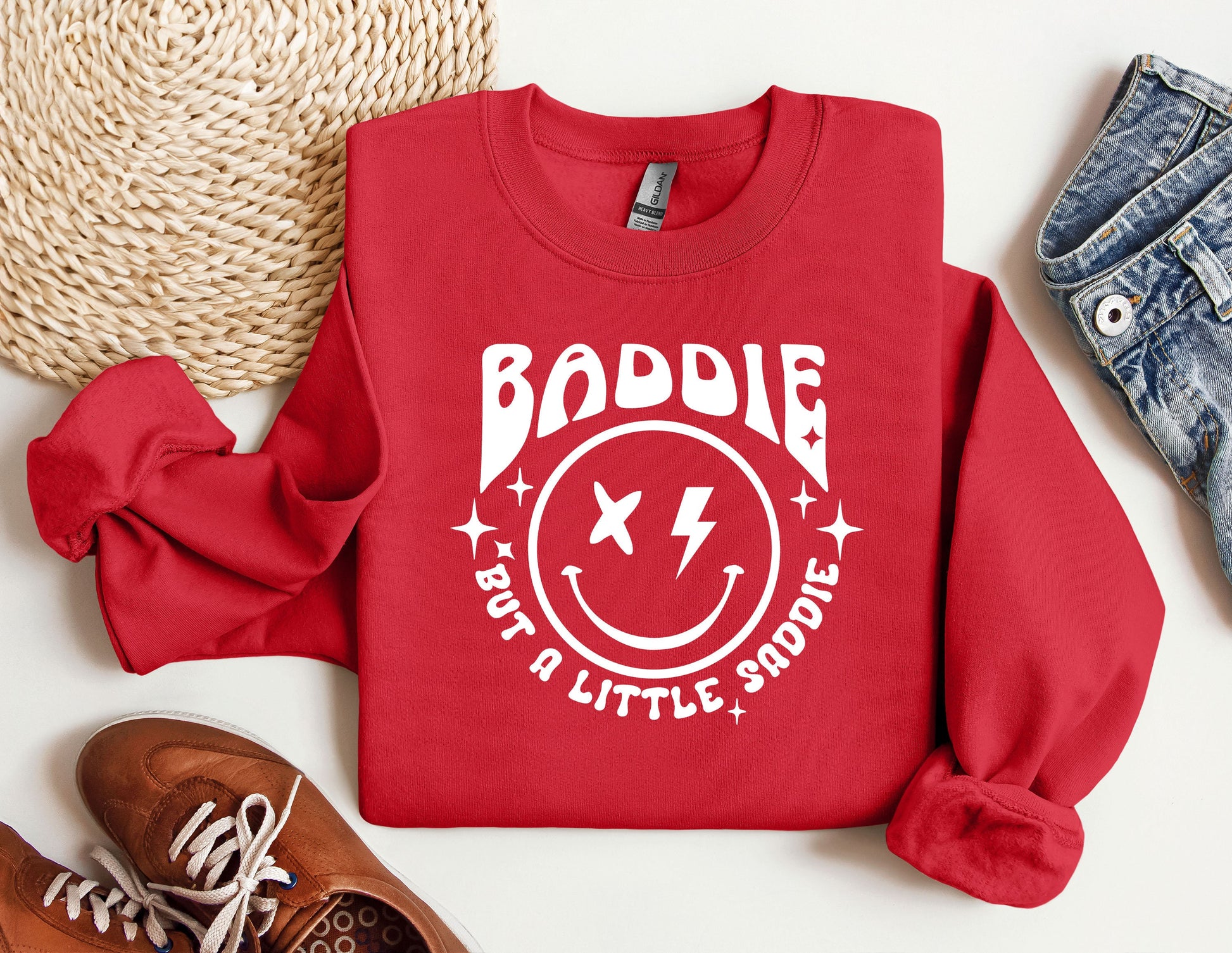 a red sweatshirt with a smiley face on it