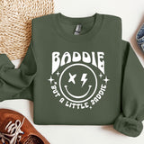 a green sweatshirt with a smiley face on it