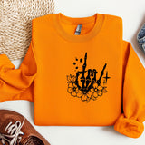 a pair of shoes and an orange sweatshirt