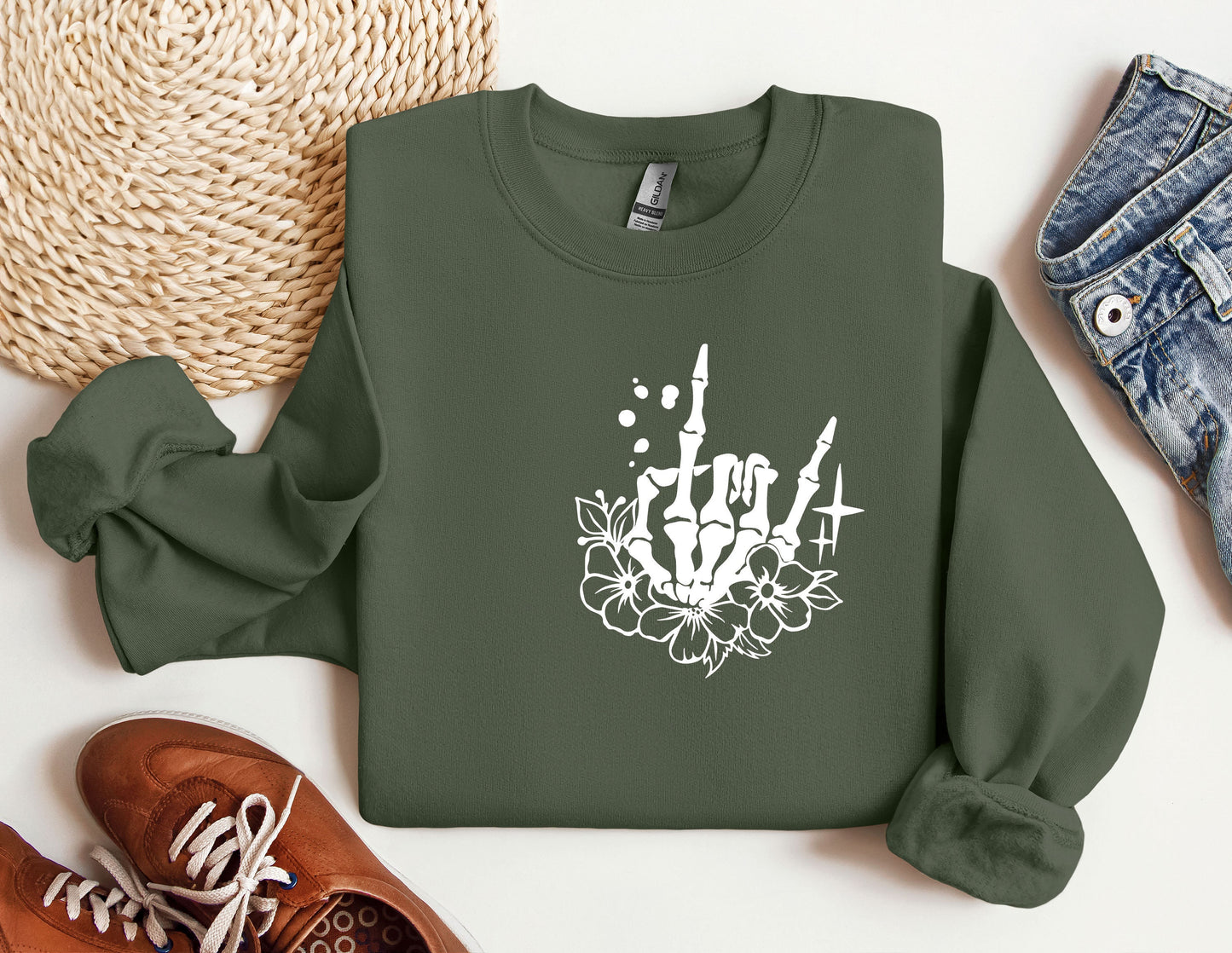 a green sweatshirt with a white design on it