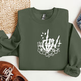 a green sweatshirt with a white design on it
