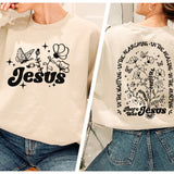 a woman wearing a sweatshirt with the word jesus printed on it