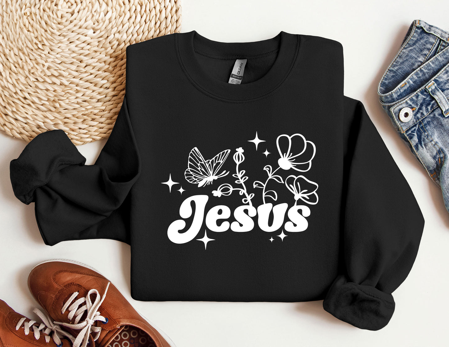 a black sweatshirt with the word jesus printed on it