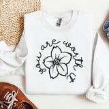 a white shirt with a flower on it