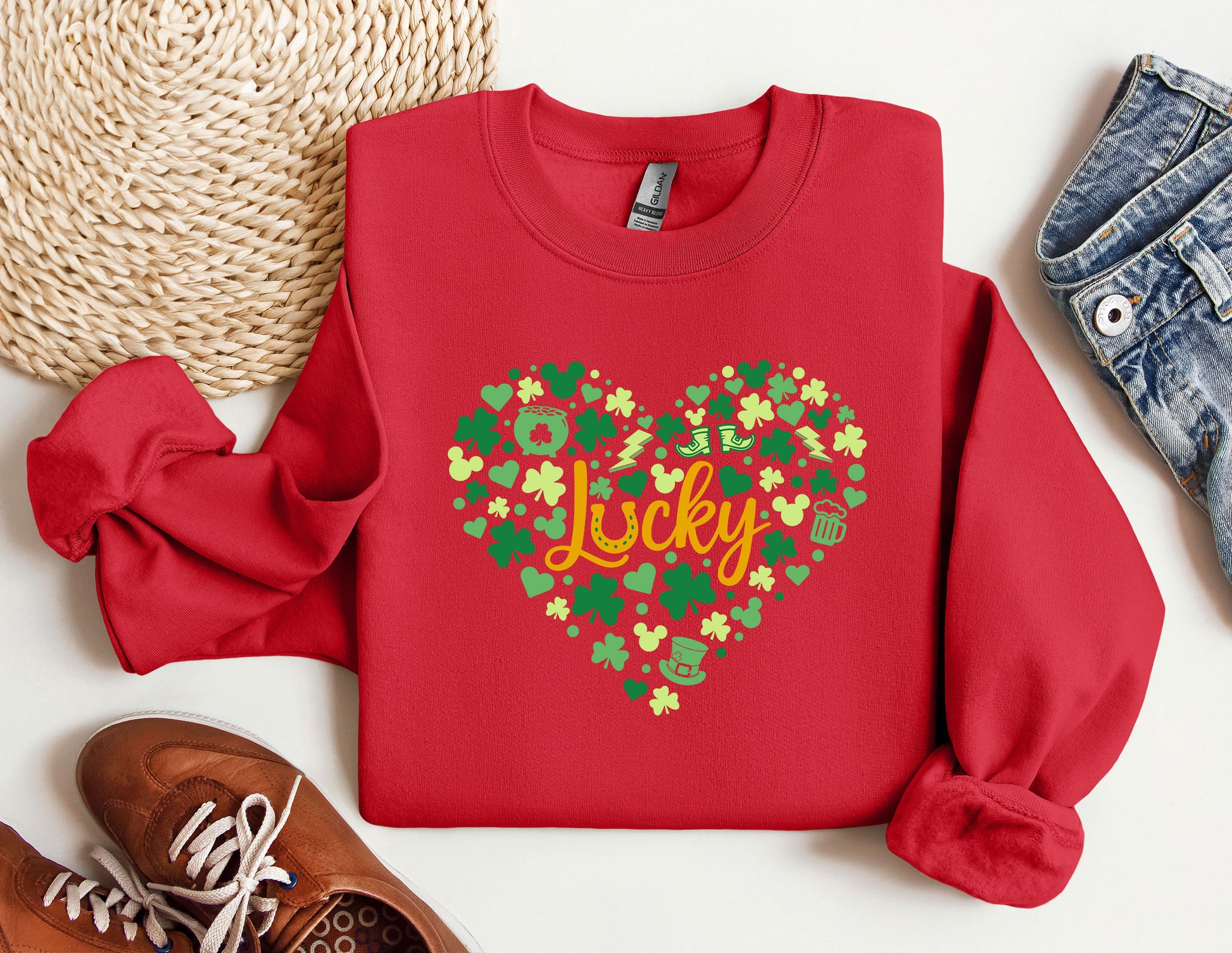 a red sweater with a heart and the word lucky printed on it