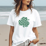 a woman standing on a beach with a hat on her head