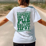 a woman in a white shirt is walking down the road