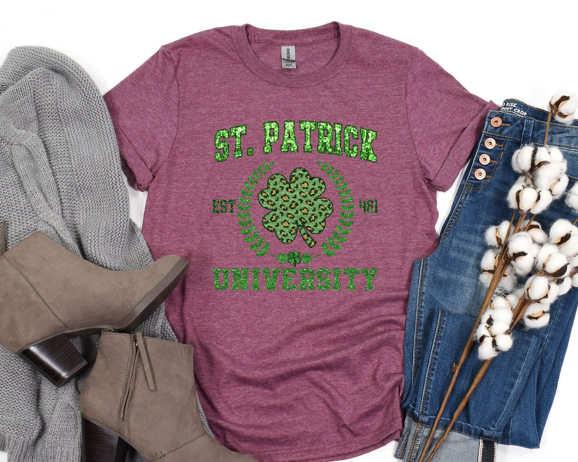 a t - shirt that says st patrick&#39;s university next to a pair of