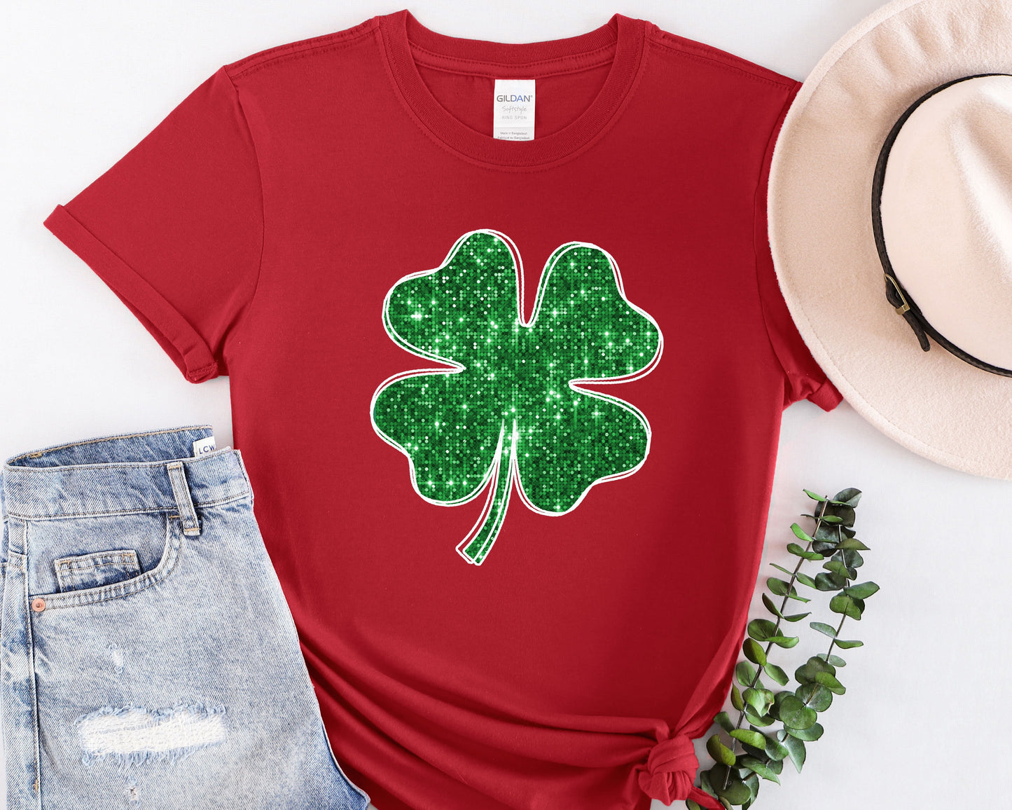 a red shirt with a green shamrock on it