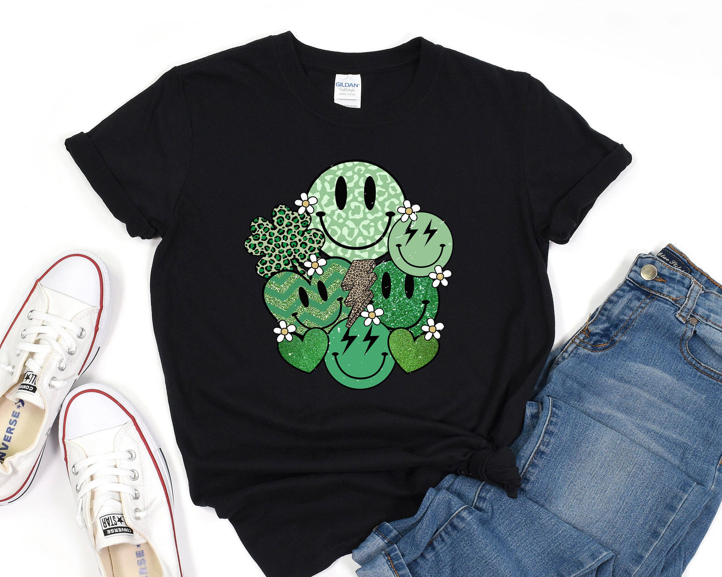 a black t - shirt with a green cartoon character on it