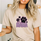 a woman wearing a t - shirt that says mama with paw prints