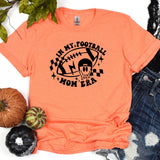 an orange shirt with a football mom bear on it