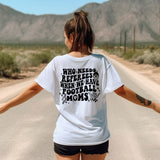 a woman walking down a road with her arms outstretched