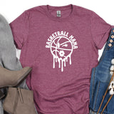 a t - shirt that says basketball mom on it next to a pair of jeans