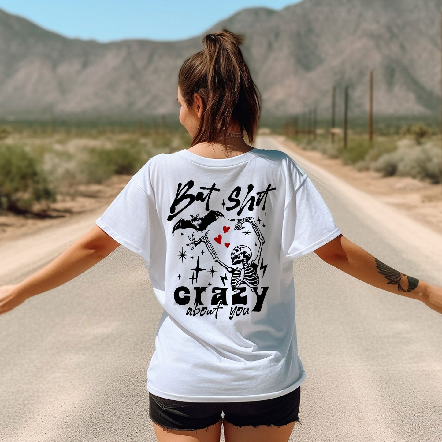 a woman walking down a road with her arms outstretched