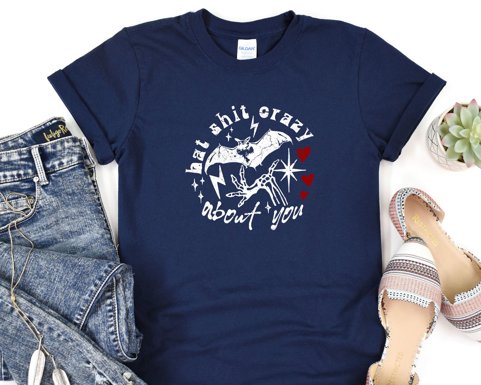 a t - shirt that says, be kind of crazy and a pair of jeans