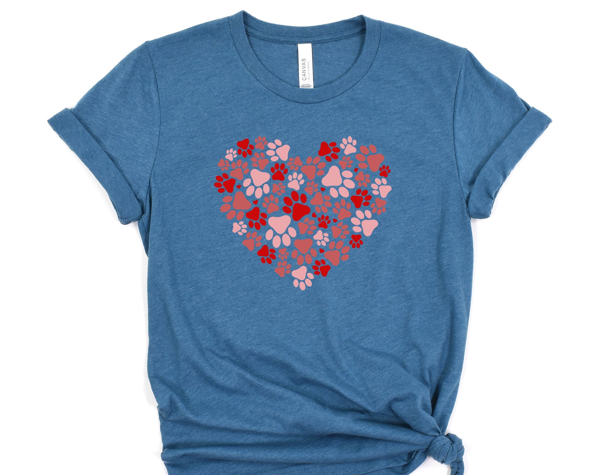 a blue t - shirt with hearts and paw prints