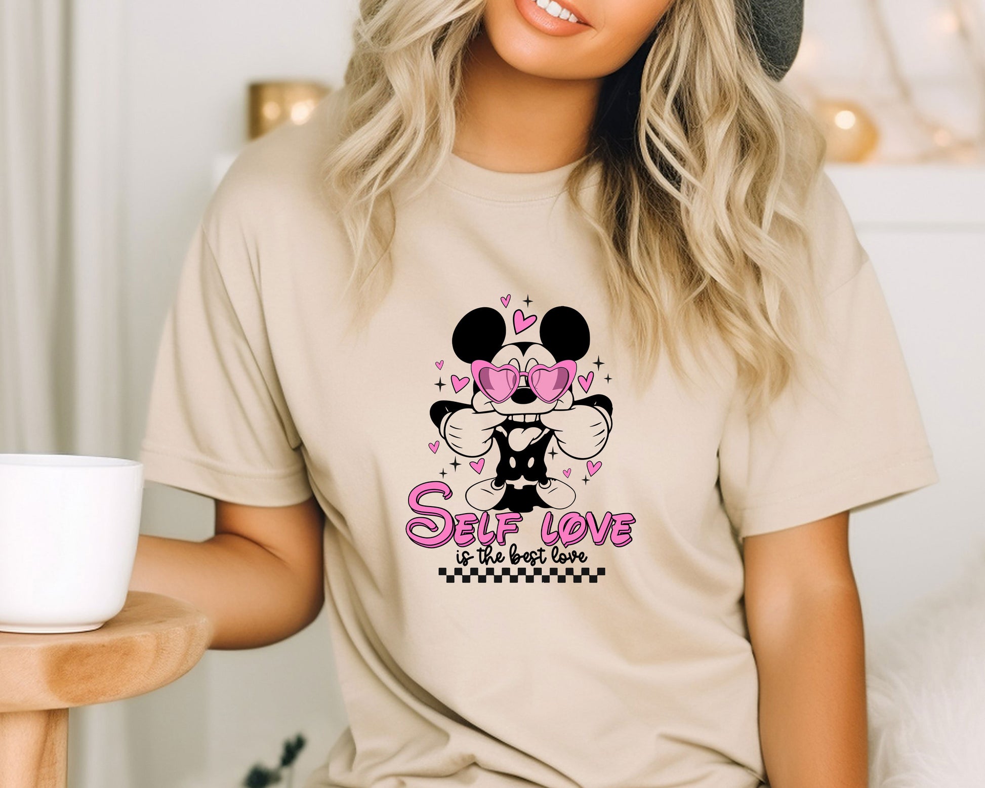 a woman wearing a mickey mouse shirt and a hat