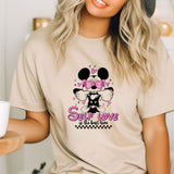 a woman wearing a mickey mouse shirt and a hat