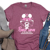 a t - shirt that says self love and a pair of jeans