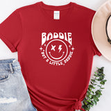 a t - shirt with a smiley face and a hat next to it