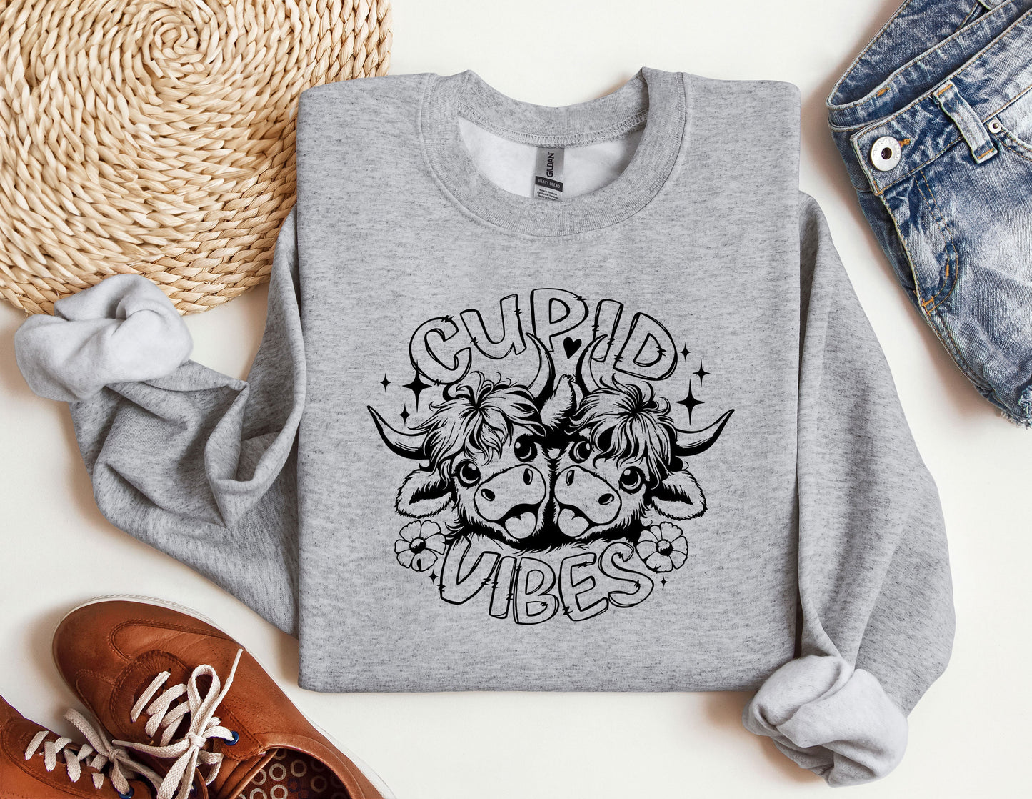 a grey sweatshirt with a graphic of a bull and the words cupid vibes